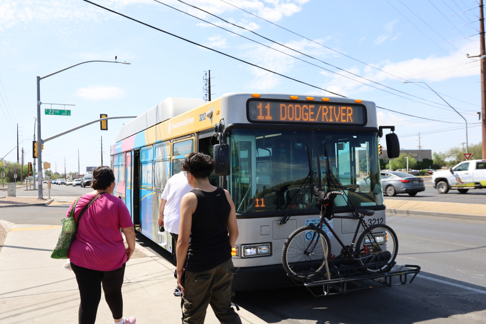 image of route 11 bus at bus stop with passengers boarding